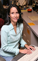 woman smiling at a keyboard